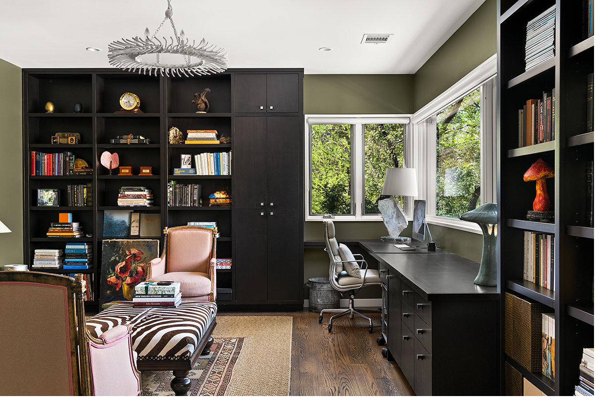 Library with olive walls and floor to ceiling shelving